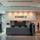 Interior of a modern JPMorgan Chase bank branch in a European city, with customers and staff.