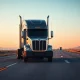 Kodiak autonomous truck on a highway at dusk, no driver visible