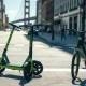 Lime electric scooters and e-bikes parked on a San Francisco street in daylight