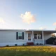 Modern manufactured home in suburban setting during golden hour