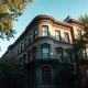 Elegant brownstone townhouse on a tree-lined street in a wealthy New York City neighborhood.