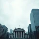 Grey London financial district skyline with Bank of England, representing UK economic uncertainty.