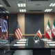 NZD/USD exchange rate on trading screen with US and Iranian flags in background representing geopolitical risk