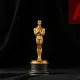 Oscar statuette with AI ban overlay representing new Academy Awards eligibility rules