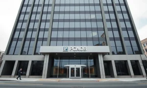 Exterior of the PCAOB headquarters building in Washington, D.C., under overcast sky.
