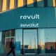 Modern Revolut building in a financial district during golden hour, symbolizing its move into private banking.
