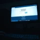 Defaced Canvas login screen with ShinyHunters extortion message in a dim school computer lab