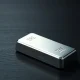 A polished silver bar on a dark wooden surface with soft studio lighting.
