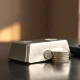 Close-up of silver bars and coins on a desk with natural light highlighting metallic shine