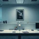 Empty desks in a modern office with a SpaceX poster, representing recent staff departures at SpaceXAI.