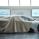 Stellantis electric vehicle prototype in a design studio with digital screens showing blueprints