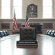 Empty chair at a Federal Reserve board meeting table in Washington D.C. signifying leadership transition.