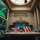 Stock exchange trading floor with green screens and diplomatic flags representing market rally and peace talks