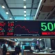 Stock market board showing S&P 500 index with red downward arrow amid inflation concerns.