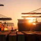 Busy container port in Taiwan at sunrise with cargo ships and cranes