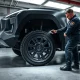 Mechanic inspecting wheel hub assembly on a Tesla Cybertruck in a service center