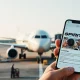 Spirit Airlines aircraft at airport gate with a smartphone showing a crowdfunding campaign in the foreground.
