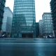 Modern glass office building in London financial district on a cloudy day representing UK financial regulation.
