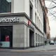 Exterior of a UniCredit bank branch on a cloudy day, representing the bank's European operations.