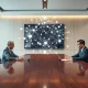 US and Chinese officials meeting with holographic AI network symbolizing cooperation