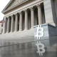 U.S. Treasury building with subtle Bitcoin reflection symbolizing macro impact on crypto markets
