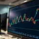 USD/CAD forex chart showing tight trading range on a monitor in a trading office