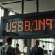 Digital forex board showing USD/INR exchange rate in a Mumbai currency exchange office