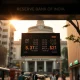 USD/INR exchange rate board in Mumbai with RBI building in background