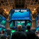 NYSE trading floor with green screens showing S&P 500 at all-time high