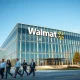 Walmart corporate headquarters building with employees leaving, illustrating recent job cuts and relocations.