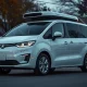 A Waymo autonomous minivan parked on a suburban street at dusk, representing the fleet recall.