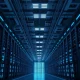 Interior view of a large, modern data center with rows of GPU servers.