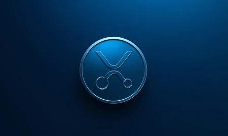 Digital XRP token icon in metallic blue and silver on a dark gradient background, representing cryptocurrency market analysis.