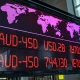 AUD/USD exchange rate board showing decline in financial district