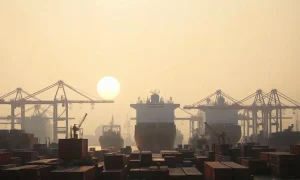 Container ship at a Chinese port at dawn, representing mixed economic signals.
