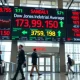 Stock market display board showing Dow Jones and semiconductor sector performance