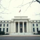 Federal Reserve building in Washington D.C. on a cloudy day, symbolizing financial regulation and economic stress tests.