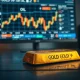 Gold bar in foreground with falling price chart and oil headlines blurred in background