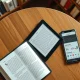 Kobo eReader next to a smartphone showing the StoryGraph app for automatic book tracking.