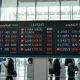 Digital currency exchange board showing MENA FX rates in a financial district.