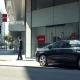 Exterior of an Avis car rental office with corporate signage on a city street