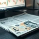 Close-up of a British £20 note with a financial chart in the background, representing Pound Sterling market volatility.