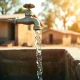 Clean water flowing from a tap in a rural village, representing Ripple's partnership with Water.org