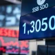 USD/SGD exchange rate displayed on a trading screen with a downward trend indicator.
