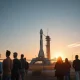 SpaceX rocket on launch pad at sunrise with retail investors watching from behind a fence