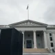 Government building in Washington D.C. with an AI server rack in the foreground, symbolizing tech regulation.