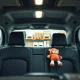 Interior of a Waymo robotaxi with a forgotten Squishmallow toy on the back seat inside an AV depot.