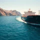 A large oil tanker navigates the strategic Strait of Hormuz waterway.