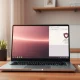 Modern laptop displaying an AI-powered browser interface on a desk with natural lighting