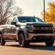 Chevrolet Silverado EV parked on a residential street in Detroit on a sunny autumn day.